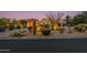 Desert landscape with three-car garage at dusk at 10542 E Skinner Dr, Scottsdale, AZ 85262