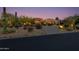Desert home with beautifully landscaped yard and exterior lighting at 10542 E Skinner Dr, Scottsdale, AZ 85262
