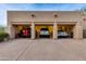 Three-car garage with multiple vehicles parked inside at 10542 E Skinner Dr, Scottsdale, AZ 85262