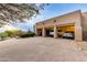 View of three-car garage from the driveway, cars parked inside at 10542 E Skinner Dr, Scottsdale, AZ 85262
