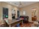 Home office with a desk, leather couch, and access to a bathroom at 10542 E Skinner Dr, Scottsdale, AZ 85262