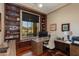 Home office with built-in shelving, a large window, and pool view at 10542 E Skinner Dr, Scottsdale, AZ 85262