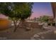 Landscaped backyard with stone pathway, mature trees, and desert landscaping at 10542 E Skinner Dr, Scottsdale, AZ 85262