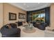 Living area with curved sectional, glass-top coffee table, and scenic views at 10542 E Skinner Dr, Scottsdale, AZ 85262
