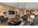 Spacious living room with leather furniture and a large flat-screen TV at 10542 E Skinner Dr, Scottsdale, AZ 85262