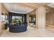 Spacious living room featuring a curved sectional sofa and large windows with scenic views at 10542 E Skinner Dr, Scottsdale, AZ 85262