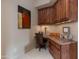 Home office with wood corner desk and built-in cabinets at 10542 E Skinner Dr, Scottsdale, AZ 85262