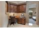 Home office with wood corner desk and built-in cabinets at 10542 E Skinner Dr, Scottsdale, AZ 85262