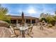 Stone patio with outdoor seating, umbrella, and views of the pool at 10542 E Skinner Dr, Scottsdale, AZ 85262