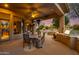 Covered patio with outdoor seating, grill, and pool views at 10542 E Skinner Dr, Scottsdale, AZ 85262