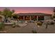 Stunning patio and pool area with seating, desert landscaping, and beautiful sunset views at 10542 E Skinner Dr, Scottsdale, AZ 85262