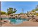 Stunning pool and spa surrounded by rocks and desert plants at 10542 E Skinner Dr, Scottsdale, AZ 85262