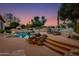 Relaxing pool and spa area with a rock waterfall feature and comfortable lounge chairs at 10542 E Skinner Dr, Scottsdale, AZ 85262