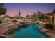 Stunning resort-style pool with a waterfall, rocks, and plenty of space for relaxation at 10542 E Skinner Dr, Scottsdale, AZ 85262