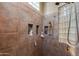 Large walk-in shower with glass block window and built-in shelves at 10542 E Skinner Dr, Scottsdale, AZ 85262