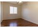 Bedroom with wood floors and window with blinds at 1146 E 6Th St, Casa Grande, AZ 85122