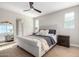 Elegant bedroom with a tufted headboard and full-length mirror at 11980 S 173Rd Ave, Goodyear, AZ 85338