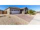 View of the home's exterior, including a brick driveway and sidewalk at 11980 S 173Rd Ave, Goodyear, AZ 85338