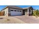 House exterior showcasing a brick driveway and two-car garage at 11980 S 173Rd Ave, Goodyear, AZ 85338