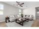 Spacious living room featuring a comfy sofa and a large coffee table at 11980 S 173Rd Ave, Goodyear, AZ 85338