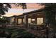 Evening view of landscaped backyard with covered patio at 12671 W Dale Ln, Peoria, AZ 85383