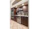 Kitchen with dark wood cabinetry, wine fridge, and double oven at 1444 W Oriole Way, Chandler, AZ 85286