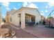 Brick patio with covered seating area and desert landscaping at 14444 W Moccasin Trl, Surprise, AZ 85374