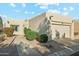 Tan stucco house with a two-car garage and manicured landscaping at 14444 W Moccasin Trl, Surprise, AZ 85374