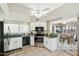 Modern kitchen with white cabinets, stainless steel appliances, and granite countertops at 14444 W Moccasin Trl, Surprise, AZ 85374