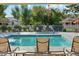 Inviting community pool with plenty of lounge chairs for relaxation at 14444 W Moccasin Trl, Surprise, AZ 85374