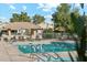 Relaxing pool area with lounge chairs, tables, and a covered patio at 14444 W Moccasin Trl, Surprise, AZ 85374