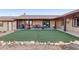 Artificial turf backyard with covered patio and mountain views at 15612 S Tuthill Rd, Buckeye, AZ 85326