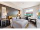 Bedroom with a queen-size bed, work station and sitting area at 17850 N 68Th St # 3027, Phoenix, AZ 85054