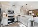 Modern white kitchen with breakfast bar and herringbone floors at 17850 N 68Th St # 3027, Phoenix, AZ 85054