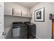 Laundry room with washer, dryer, and overhead shelving at 17850 N 68Th St # 3027, Phoenix, AZ 85054