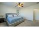 Spacious bedroom with a queen bed, nightstand and ceiling fan at 1792 W Loemann Dr, San Tan Valley, AZ 85144