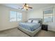 Bright bedroom with a queen bed, nightstand, and ceiling fan at 1792 W Loemann Dr, San Tan Valley, AZ 85144