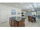 Open kitchen with granite island and stainless steel appliances at 1792 W Loemann Dr, San Tan Valley, AZ 85144