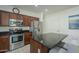 Kitchen features stainless steel appliances and granite island at 1792 W Loemann Dr, San Tan Valley, AZ 85144