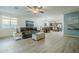 Spacious living area with leather couch and view into kitchen at 1792 W Loemann Dr, San Tan Valley, AZ 85144
