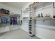 Spacious walk-in closet with shelving and hanging space for shoes and clothes at 1792 W Loemann Dr, San Tan Valley, AZ 85144