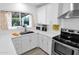 Modern kitchen with white cabinets, stainless steel appliances, and quartz countertops at 20219 N 10Th Ave, Phoenix, AZ 85027