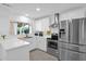 Modern kitchen with white cabinets, stainless steel appliances, and quartz countertops at 20219 N 10Th Ave, Phoenix, AZ 85027