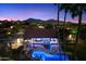 Stunning nighttime view of home, pool, and city lights at 24218 N 85Th St, Scottsdale, AZ 85255