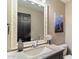 Bathroom with granite vanity, decorative mirror, and Grand Canyon art at 24218 N 85Th St, Scottsdale, AZ 85255