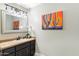 Chic bathroom with dark vanity, tile shower, and decorative mirror at 24218 N 85Th St, Scottsdale, AZ 85255