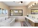 Bathroom with double vanity, soaking tub, and large window at 24218 N 85Th St, Scottsdale, AZ 85255