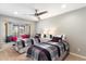 Bright bedroom with two twin beds, window seat, and ceiling fan at 24218 N 85Th St, Scottsdale, AZ 85255