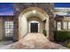 Elegant home exterior entrance with stone archway and double doors at 24218 N 85Th St, Scottsdale, AZ 85255