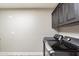 Functional laundry room with washer, dryer, and upper cabinets at 24218 N 85Th St, Scottsdale, AZ 85255
